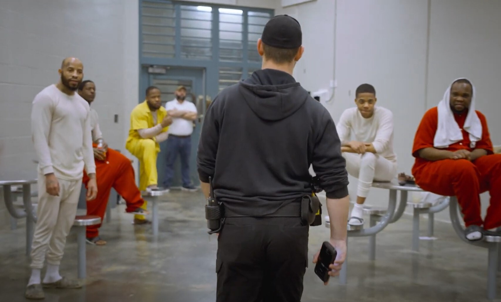 CO walking through pod with inmates hanging out CO walking through pod with inmates hanging out