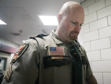 Correctional officer looking down