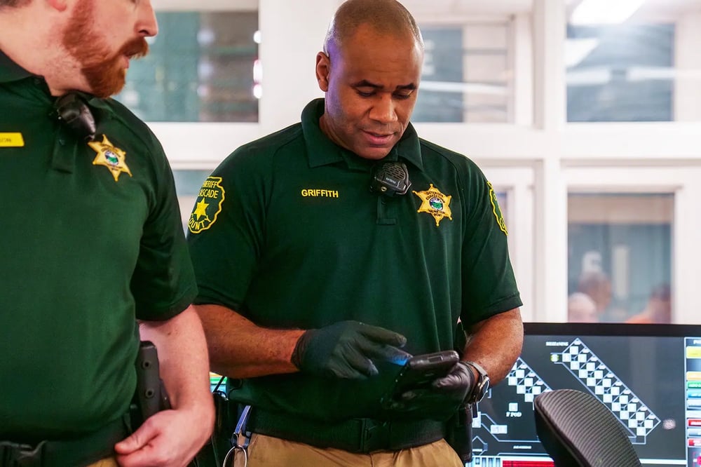 Two correctional officers huddling copy
